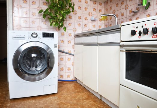 white lg washing machine in bathroom